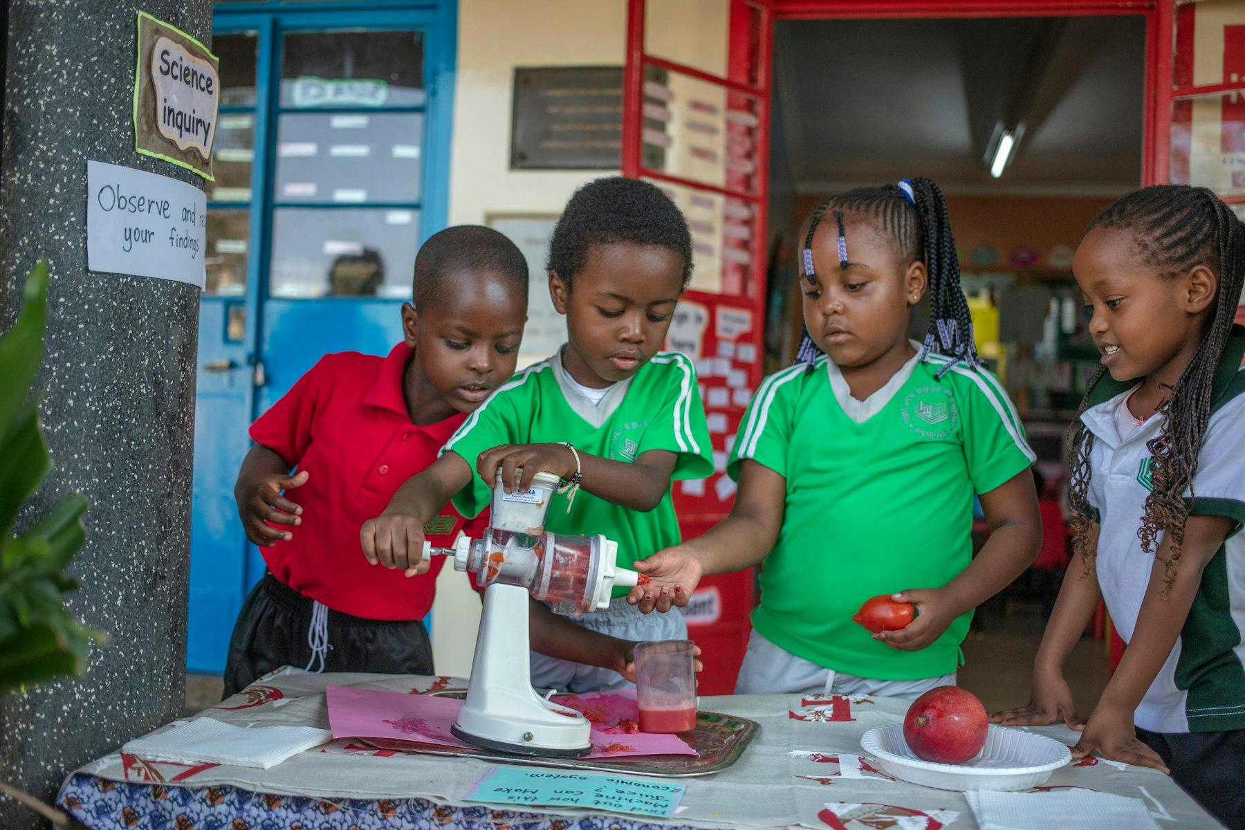 Students at the Academy work together during Friday morning’s science experiment.