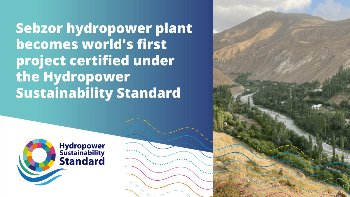 Mountains, valleys and a river with the text “Sebzor hydropower plant becomes world’s first project certified under the Hydropower Sustainability Standard”.