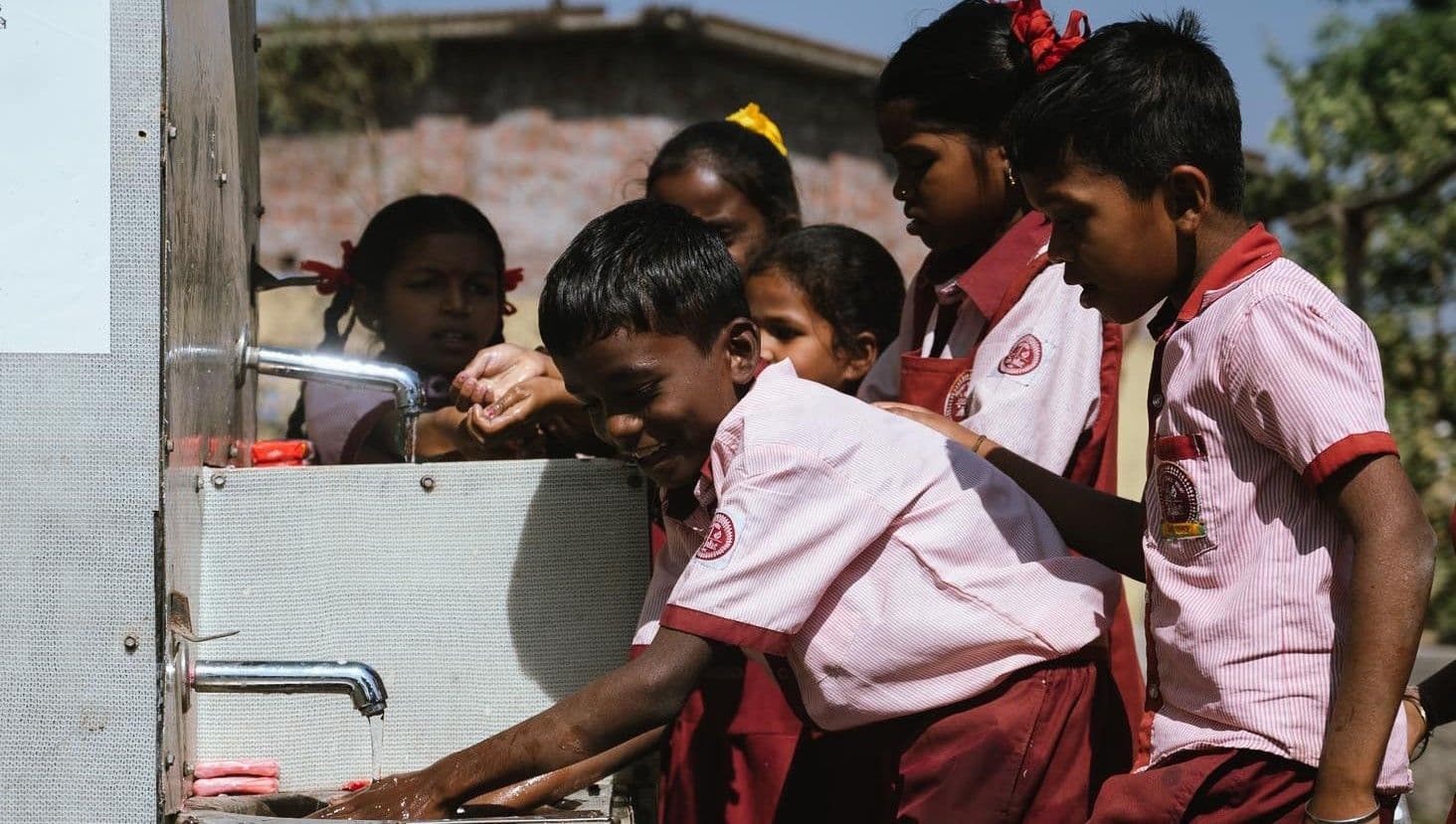 Children wash their hands at school. Improved access to water, together with activities promoting water conservation and hygiene, leads to better wellbeing.